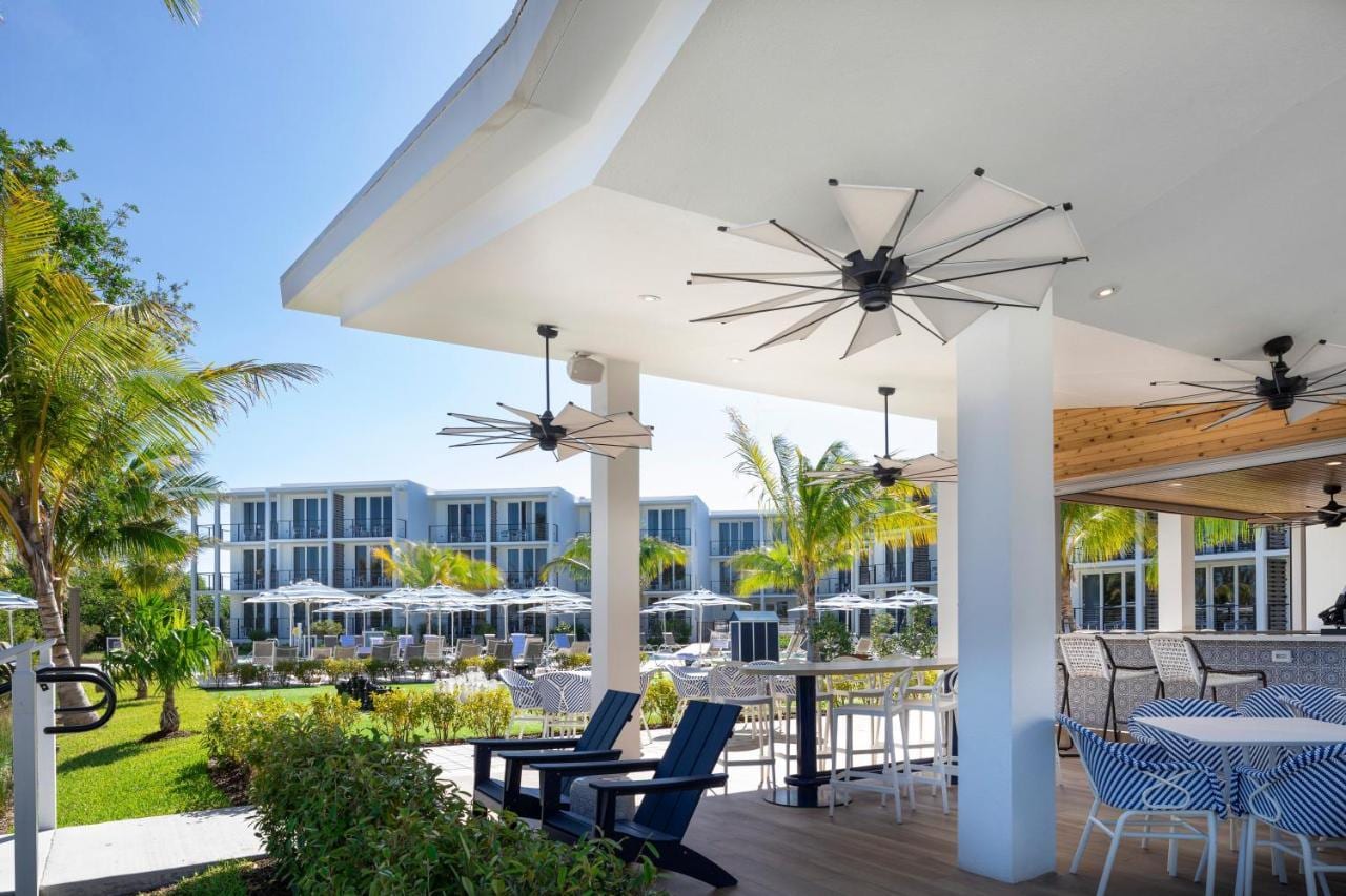 Covered waterfront terrace at Capitana Key West with ceiling fans and downlighting