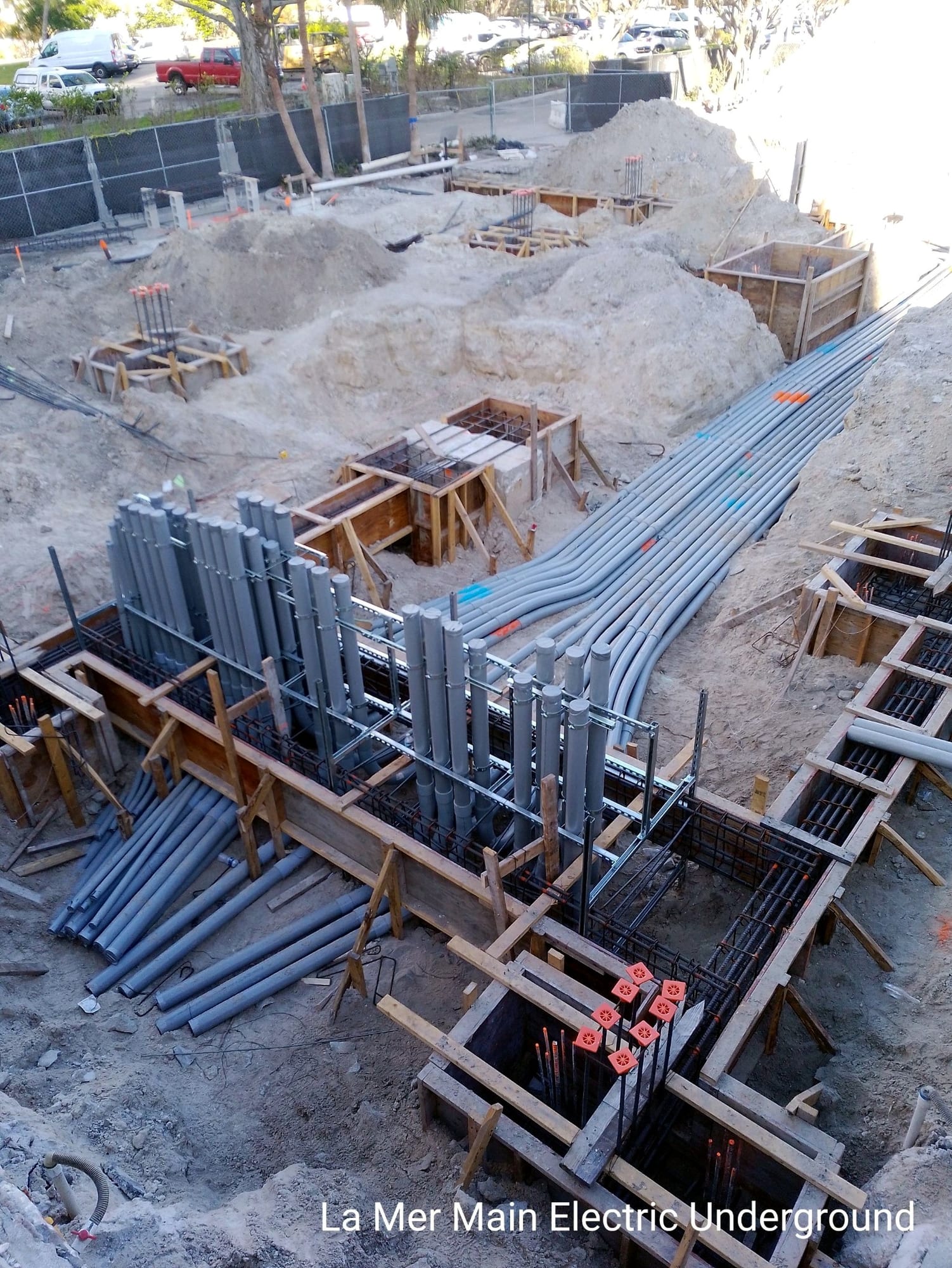 Conduit stub-ups set in formwork and rebar at the service entrance excavation