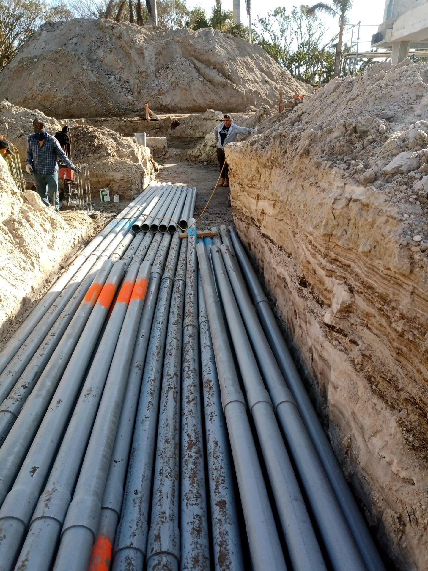 Duct bank conduits laid in a rock trench during underground installation
