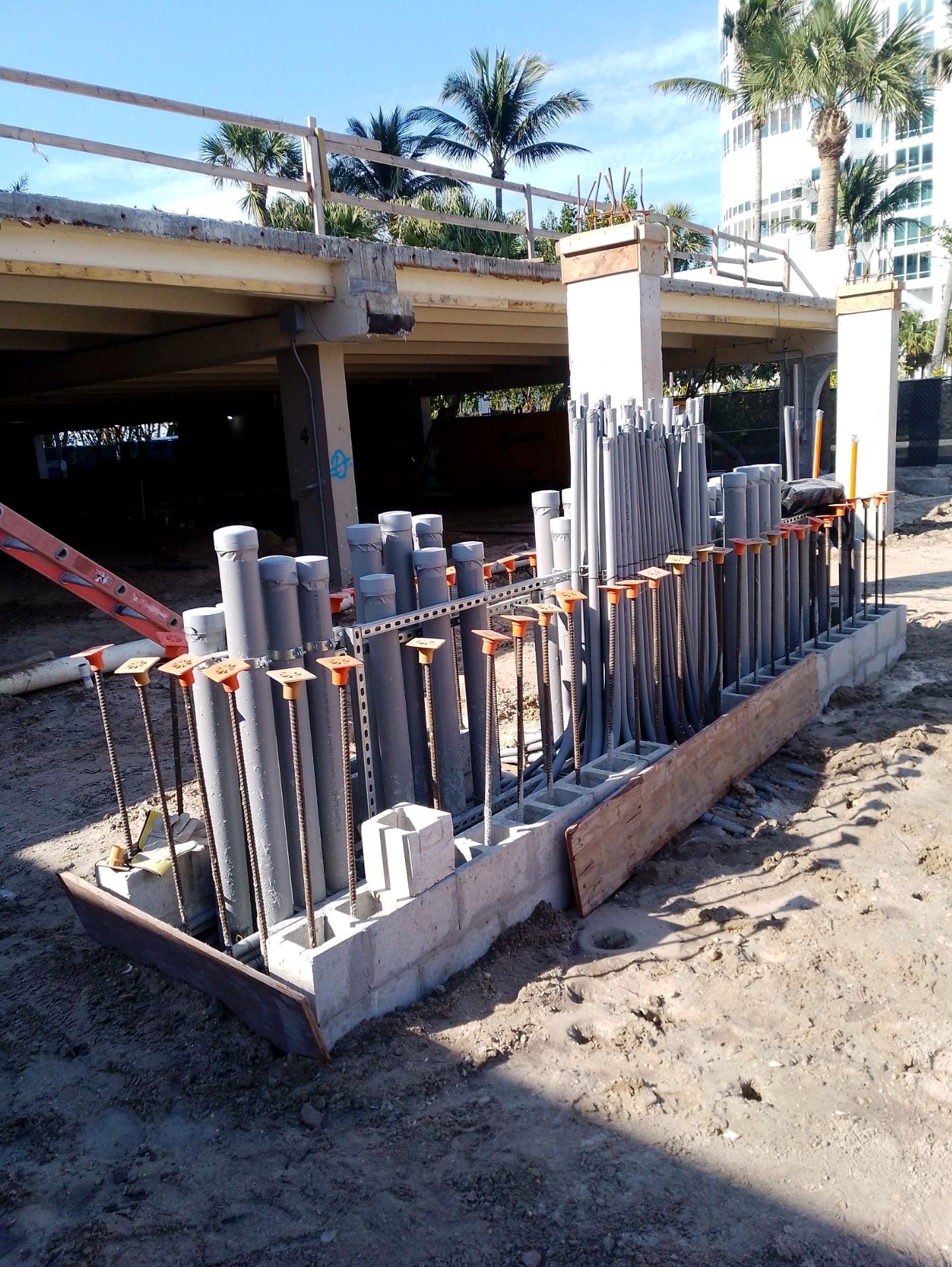 Bank of vertical conduit stub-ups framed beneath the building
