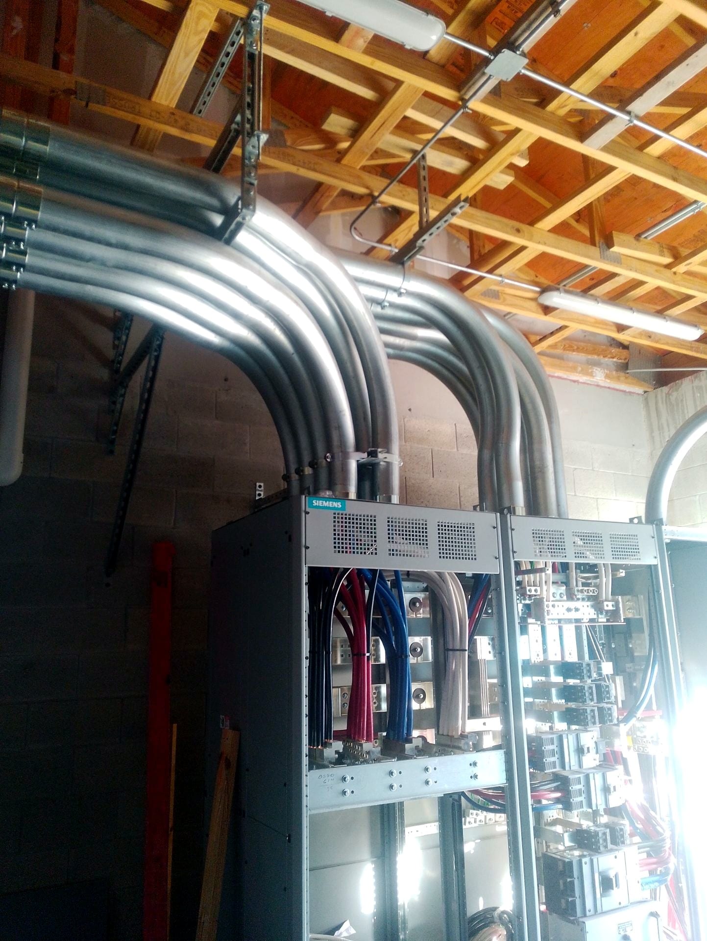 Large feeder conduits sweeping into new distribution equipment