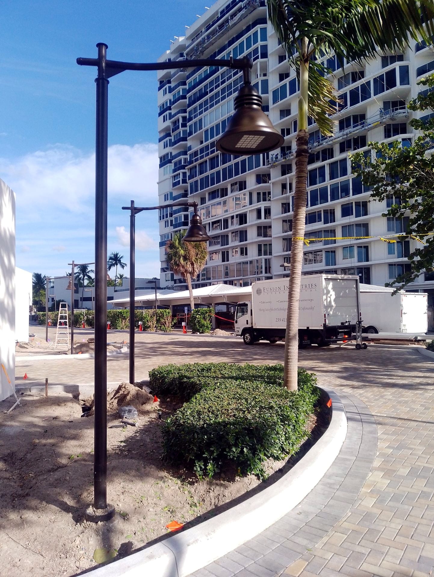 New site lighting outside the La Mer high-rise with a Check Electric truck on site