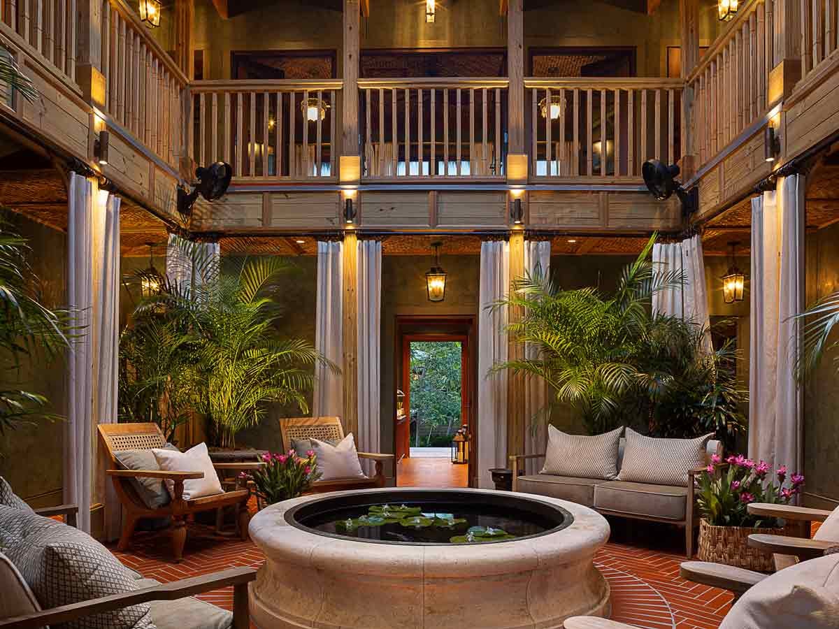 Little Palm Island great room with a double-height ceiling and layered lighting