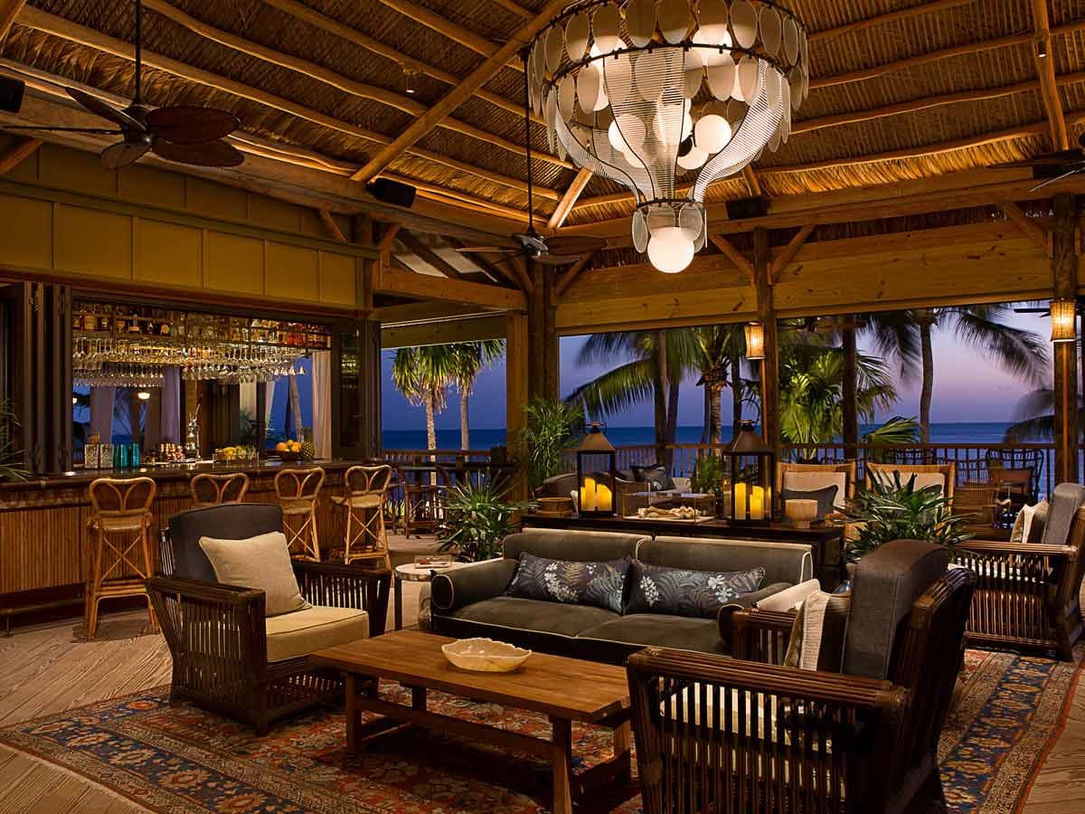 Resort lounge and bar at Little Palm Island with pendant lighting