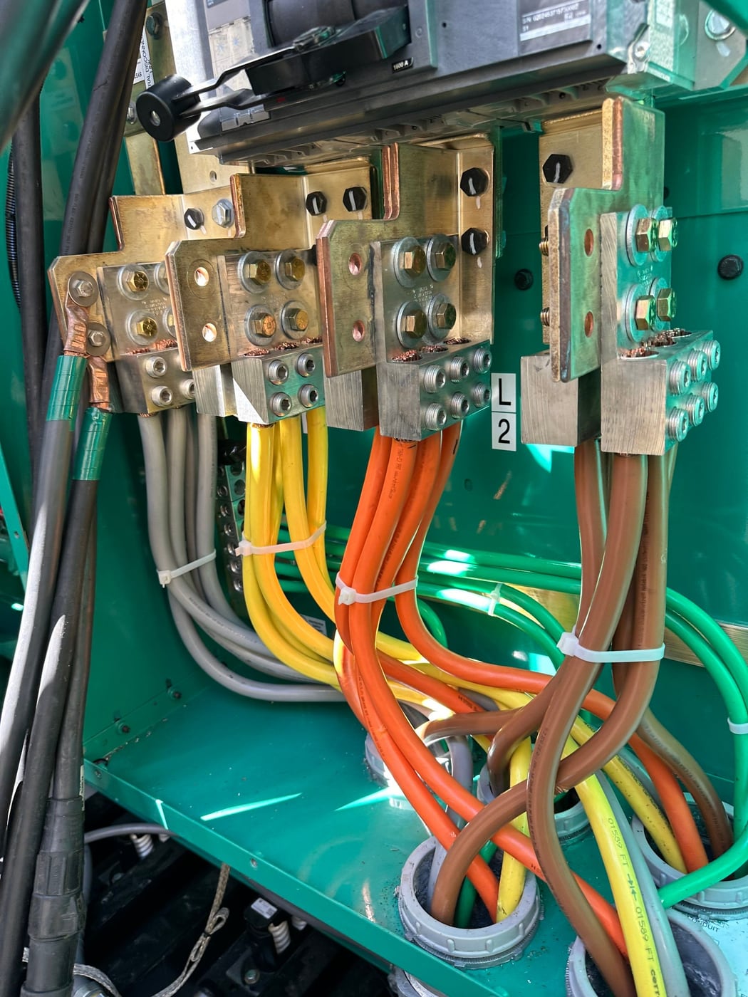 Feeder terminations landed on the generator lugs, phases tagged and torqued