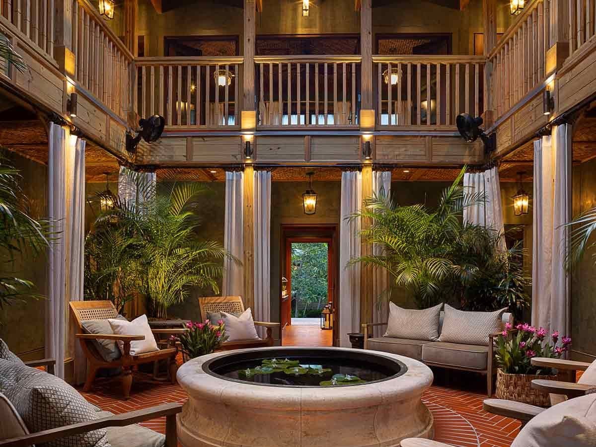 Little Palm Island great room with a double-height ceiling and layered lighting