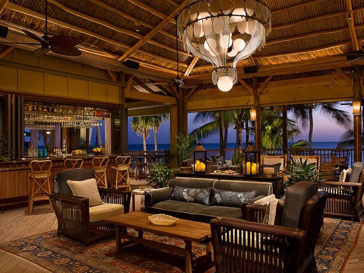 Resort lounge and bar at Little Palm Island with pendant lighting